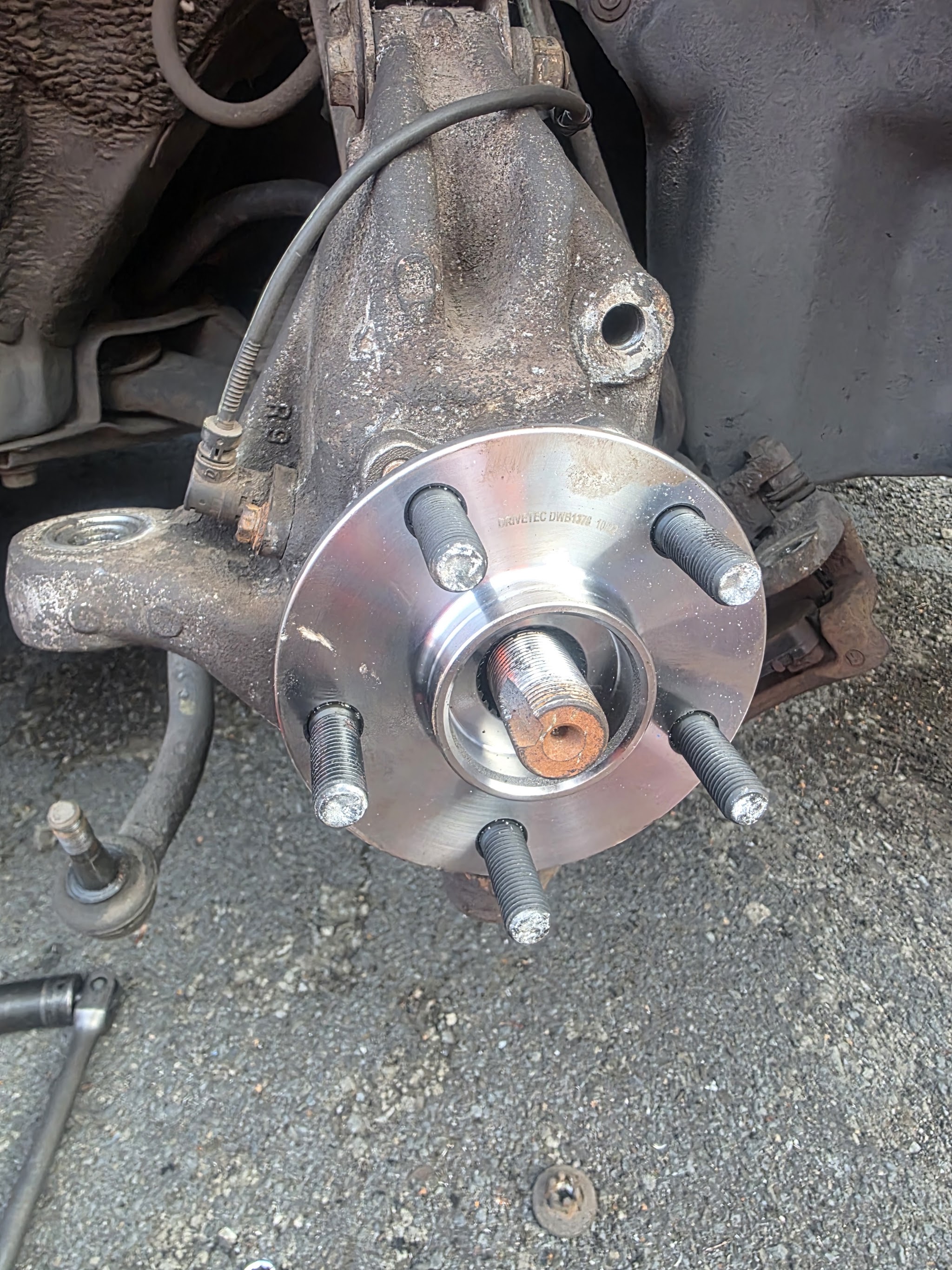 A new wheel hub with fresh studs fitted to a steering knuckle